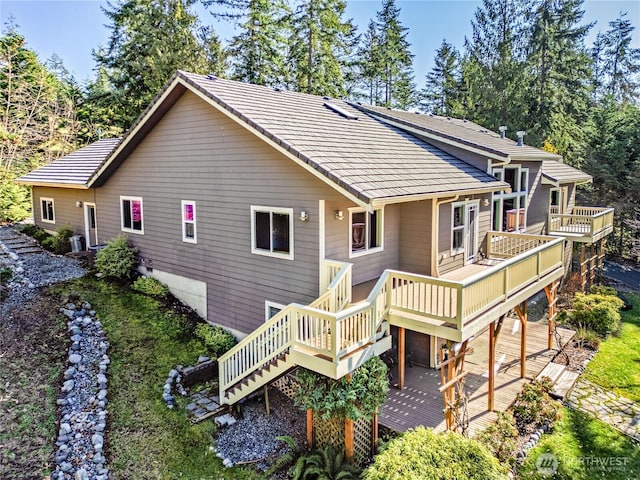 rear view of house featuring a deck