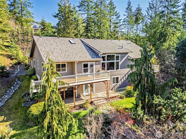 rear view of property with a wooden deck