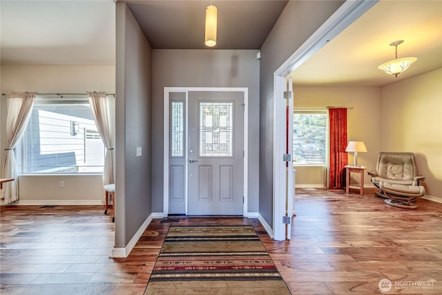 foyer with wood finished floors and baseboards