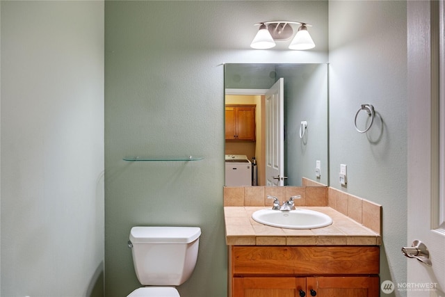 bathroom featuring vanity and toilet