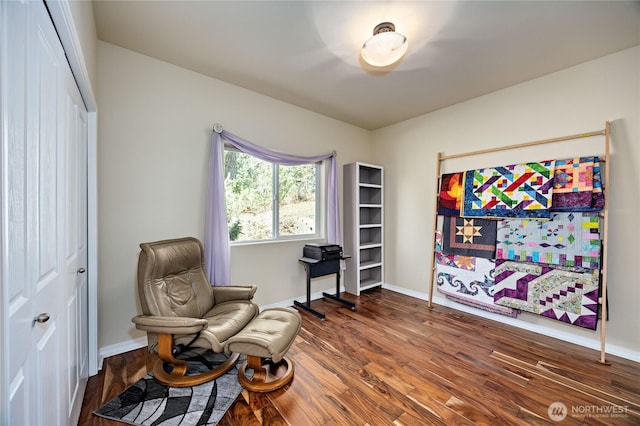 living area featuring baseboards and wood finished floors