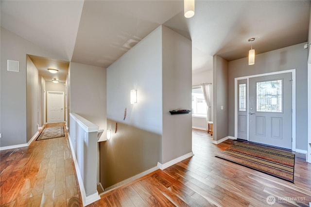 entrance foyer with baseboards and hardwood / wood-style floors