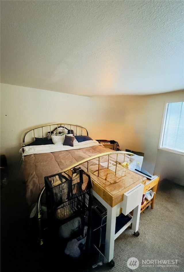 carpeted bedroom with a textured ceiling