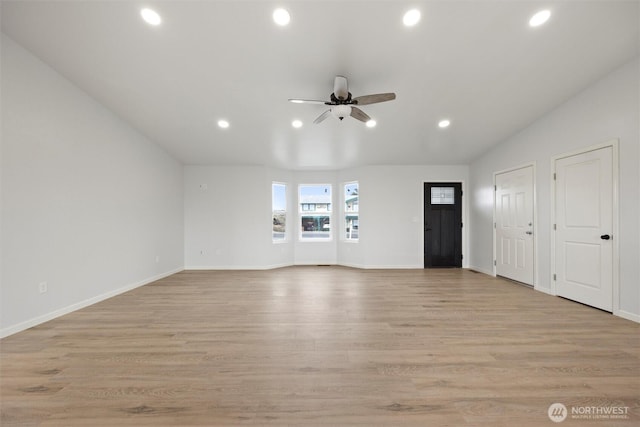 unfurnished living room featuring light wood finished floors, recessed lighting, a ceiling fan, vaulted ceiling, and baseboards