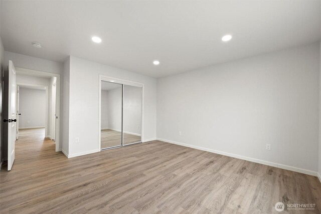 unfurnished bedroom featuring light wood-style floors, recessed lighting, a closet, and baseboards