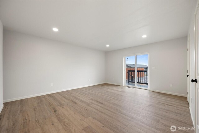 unfurnished room featuring light wood-style flooring, baseboards, and recessed lighting