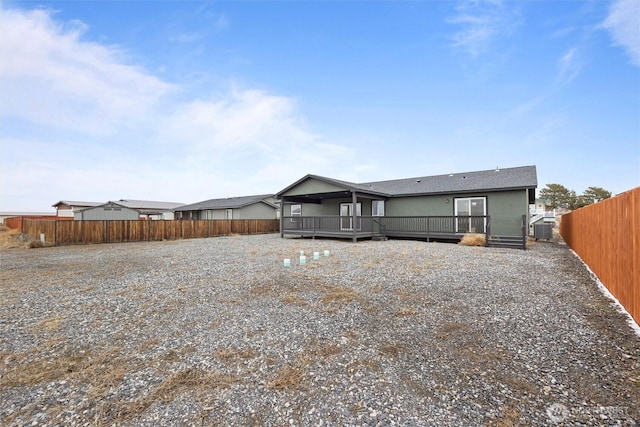 rear view of house featuring a deck, a fenced backyard, and central air condition unit