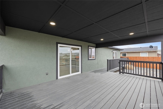 wooden terrace featuring fence