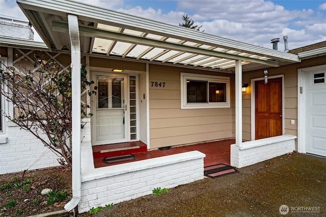 view of exterior entry featuring a garage