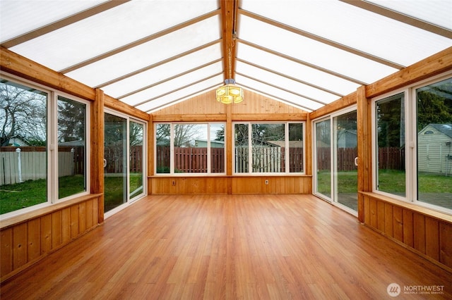 unfurnished sunroom with lofted ceiling with beams