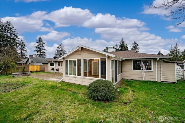 rear view of property with a yard, a patio area, and fence