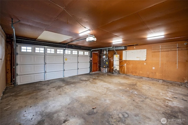 garage with heating unit, a garage door opener, and water heater