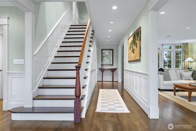 entryway featuring a wainscoted wall, dark wood finished floors, recessed lighting, a decorative wall, and ornamental molding