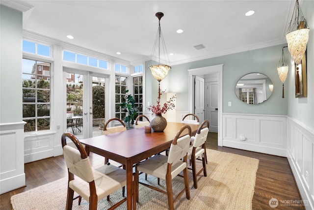 dining space with dark wood-type flooring, recessed lighting, french doors, and ornamental molding