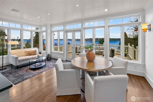 sunroom / solarium featuring a water view