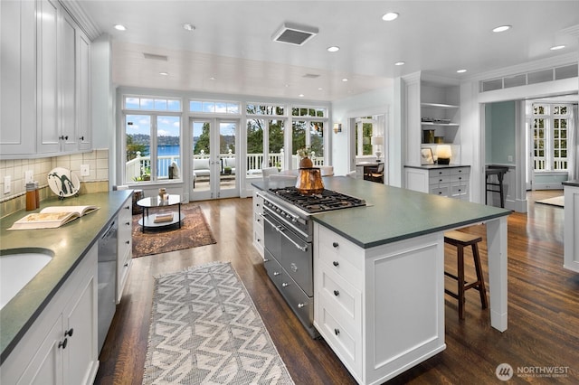 kitchen with french doors, dark countertops, dark wood finished floors, and white cabinets