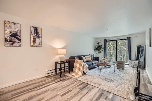 living room featuring baseboards, baseboard heating, and wood finished floors