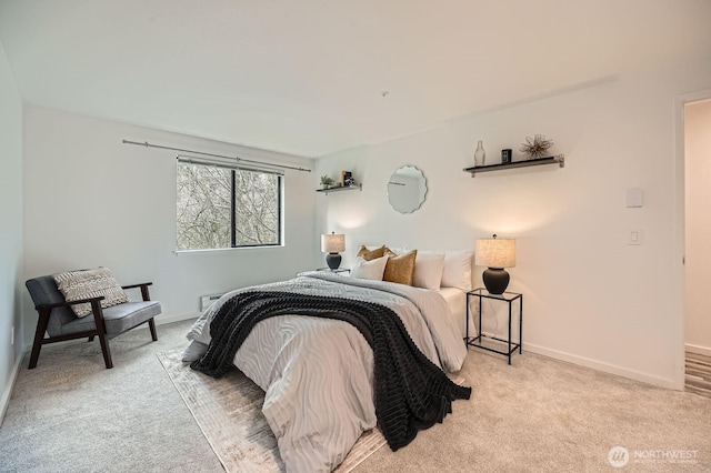 bedroom with light colored carpet and baseboards