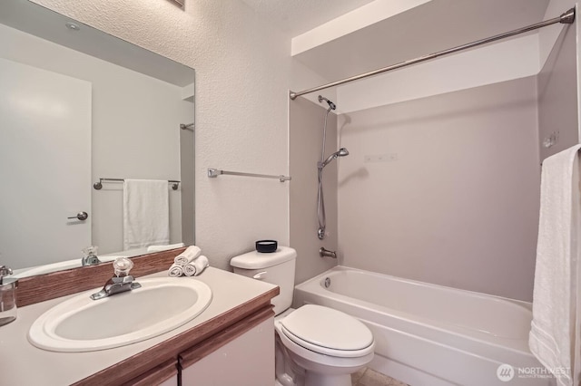 bathroom with shower / washtub combination, vanity, and toilet