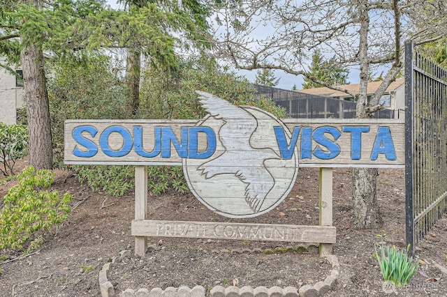 community / neighborhood sign with fence