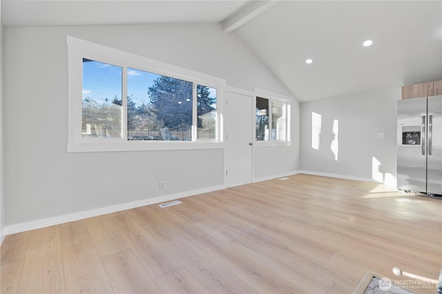 unfurnished living room with lofted ceiling with beams, light wood-style floors, baseboards, and visible vents