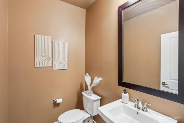 bathroom with toilet and a sink