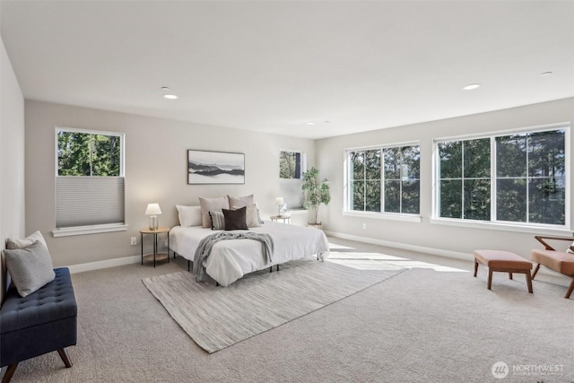 carpeted bedroom with multiple windows, recessed lighting, and baseboards