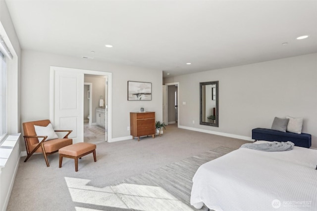 bedroom with light carpet, baseboards, ensuite bathroom, and recessed lighting