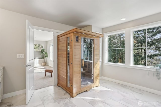 entryway with marble finish floor, a sauna, and baseboards