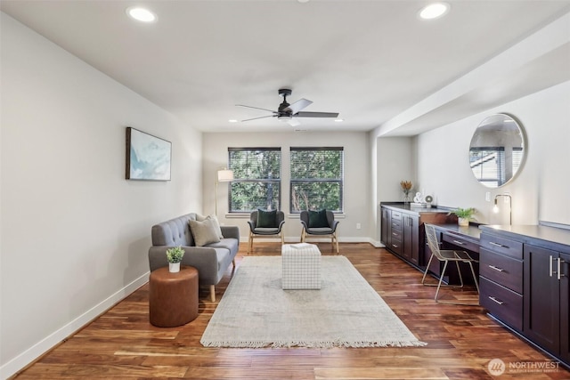 living room featuring recessed lighting, dark wood finished floors, and baseboards