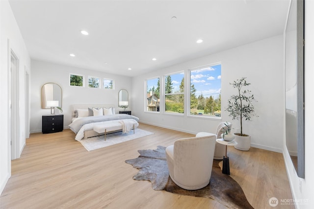 bedroom with baseboards, light wood-type flooring, and recessed lighting