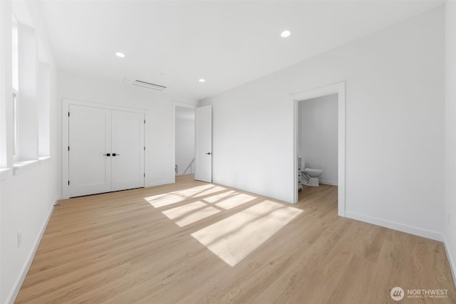 unfurnished bedroom with light wood-style floors, recessed lighting, a closet, and baseboards