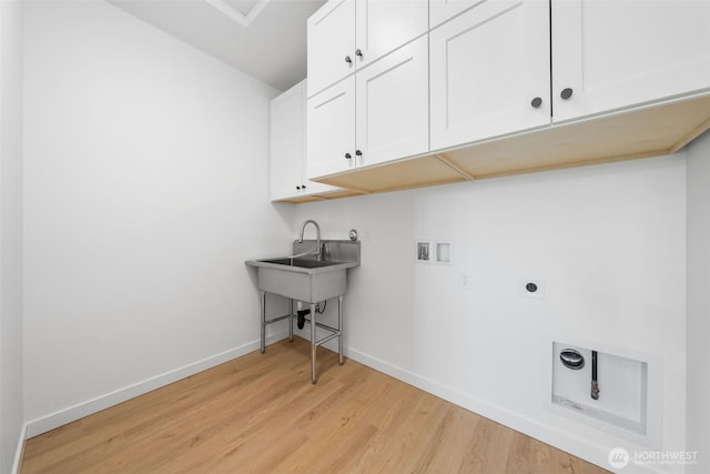 laundry area with cabinet space, baseboards, hookup for an electric dryer, light wood-style floors, and washer hookup