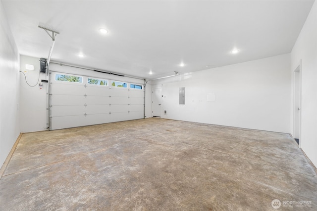 garage with recessed lighting and electric panel