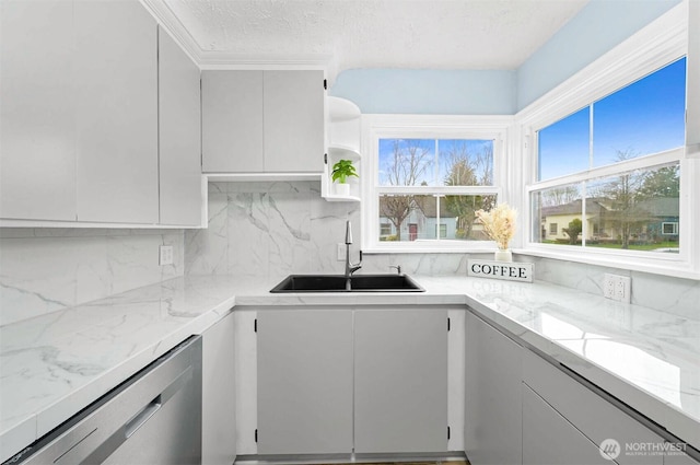 kitchen featuring open shelves, a sink, a textured ceiling, dishwasher, and tasteful backsplash