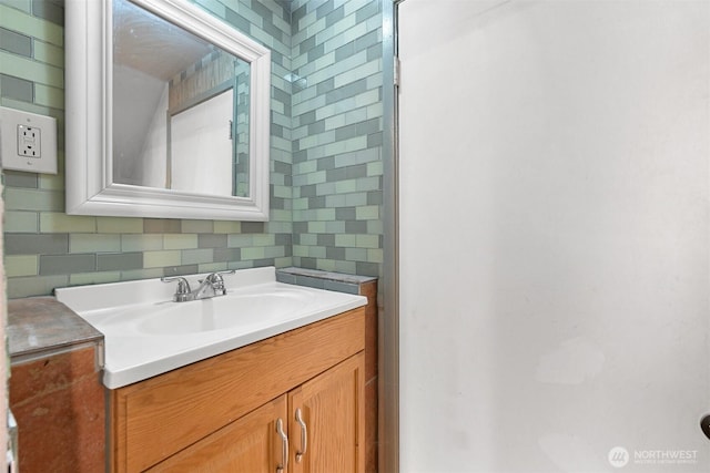 bathroom with vanity and tasteful backsplash