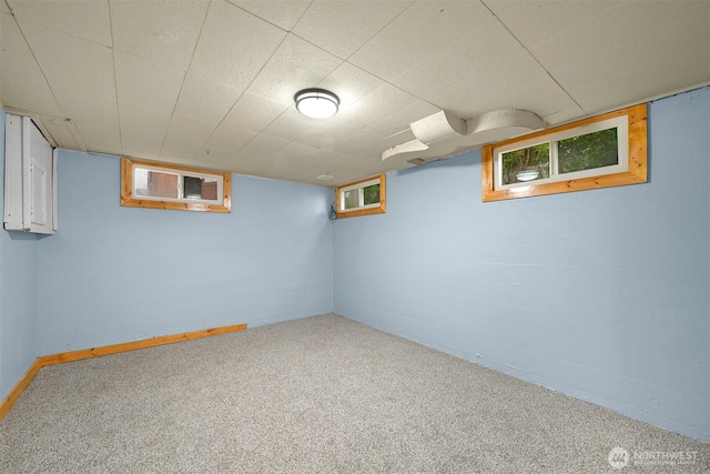 basement with carpet, baseboards, and a wealth of natural light