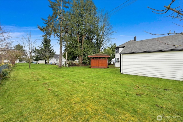 view of yard with an outdoor structure and a shed