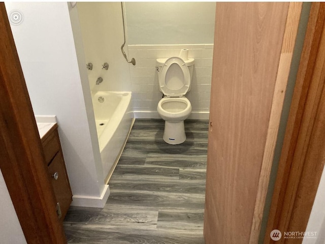 11057 Greenwood Ave N, Seattle, WA 98133 - full bathroom with tile walls, vanity, toilet, and wood finished floors