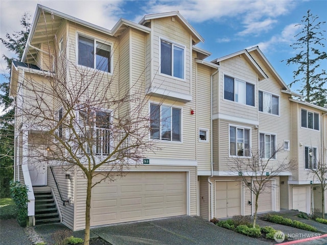 multi unit property featuring an attached garage and entry steps