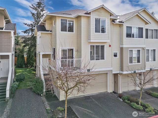 view of property with a garage and driveway