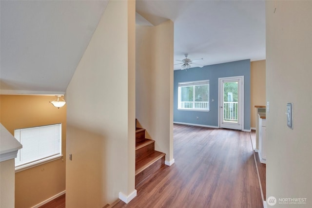 interior space with ceiling fan, baseboards, and wood finished floors