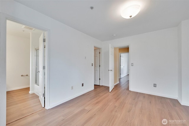 unfurnished bedroom featuring baseboards and light wood-style floors