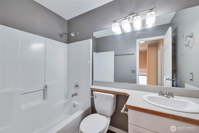 bathroom with toilet, tub / shower combination, and vanity