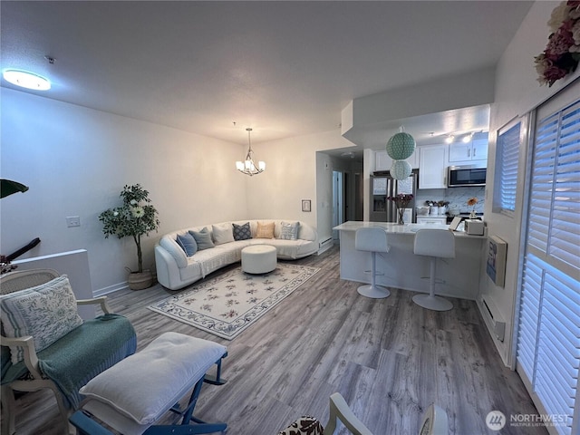 living area with an inviting chandelier and wood finished floors