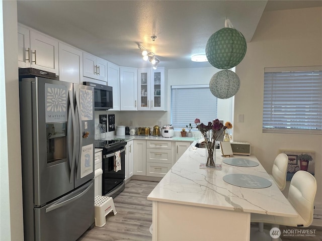 kitchen featuring a peninsula, white cabinets, black range with electric cooktop, glass insert cabinets, and stainless steel refrigerator with ice dispenser