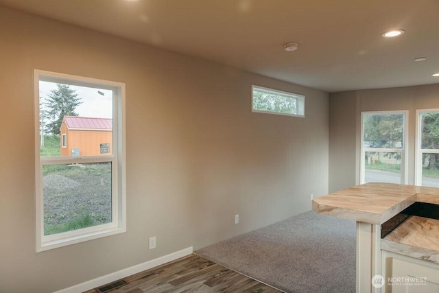 spare room with baseboards, recessed lighting, visible vents, and light wood-style floors