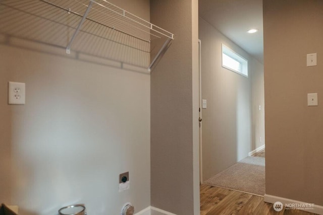 laundry area with recessed lighting, hookup for an electric dryer, laundry area, wood finished floors, and baseboards