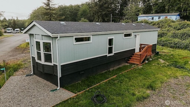 back of house featuring roof with shingles and crawl space