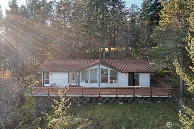 view of front of property with a tiled roof and a deck